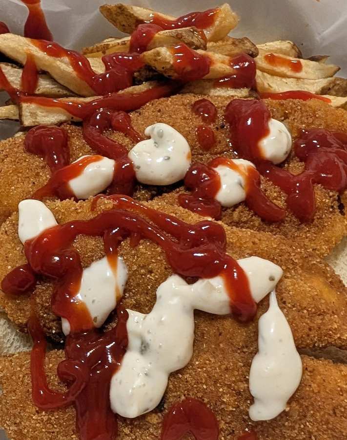 Fried fish and potato fries finished with two sauces