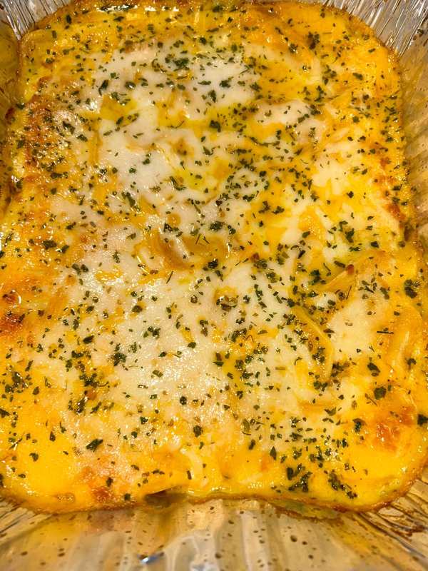 A full pan of baked macaroni and cheese with a golden top