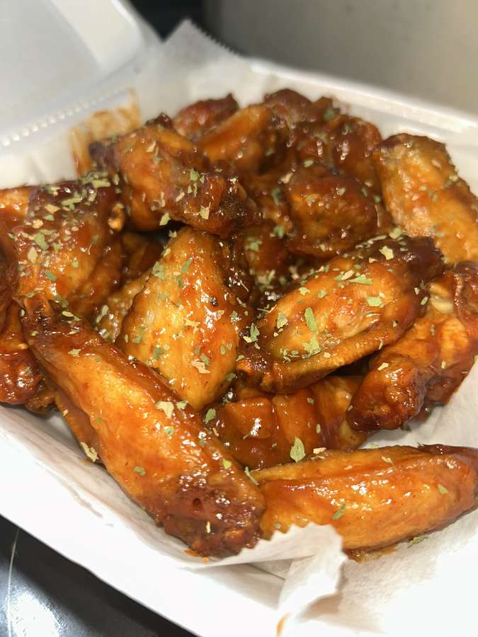 Tray of glossy sauced chicken wings
