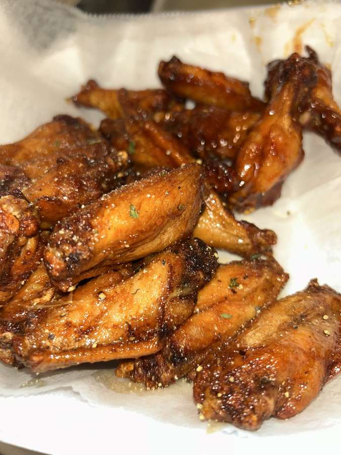 Close-up of glazed and seasoned chicken wings