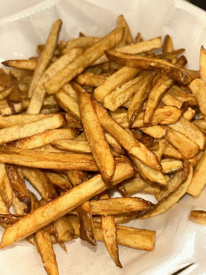 A generous tray of homemade potato-cut fries